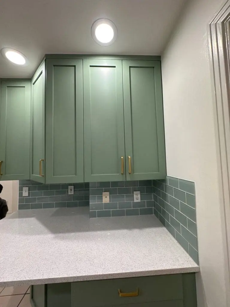 Modern sage green kitchen cabinets professionally spray-finished by painters at Refined Painting LLC in Seattle, WA.