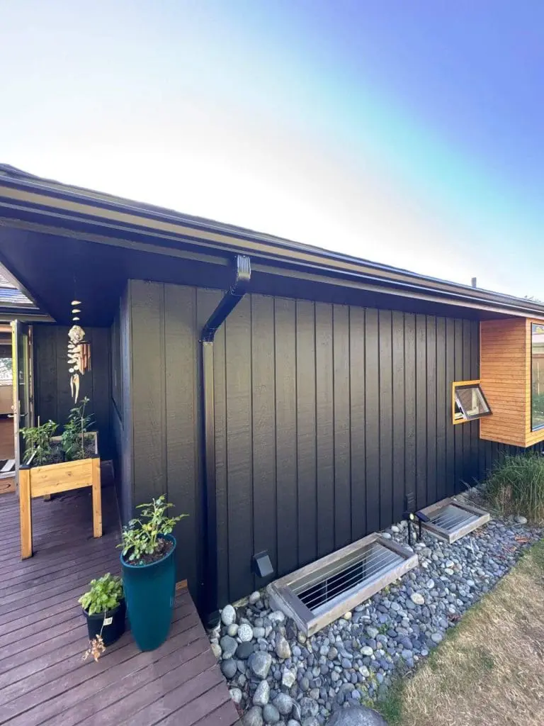 Modern black vertical siding home exterior professionally finished by Painters in Refined Painting LLC in Seattle, WA, featuring sleek trim and natural wood accents.