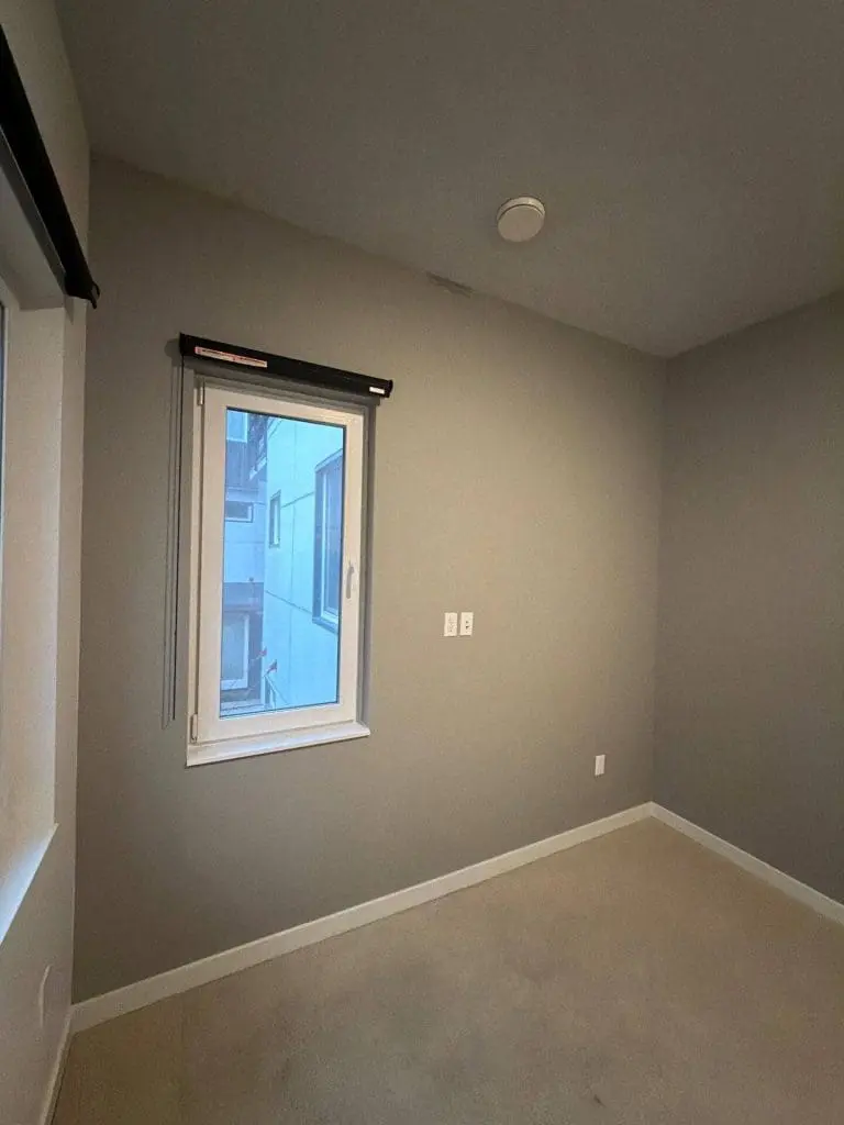 Freshly painted bedroom interior with smooth neutral walls completed by Refined Painting, showcasing professional interior painting in Seattle