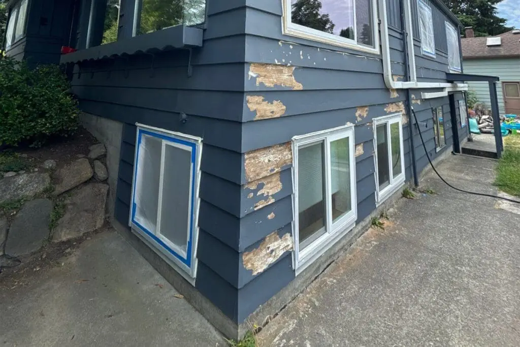 Exterior siding with peeling and faded paint, showing what fading paint means for long-term surface protection on a residential home.
