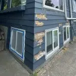 Exterior siding with peeling and faded paint, showing what fading paint means for long-term surface protection on a residential home.